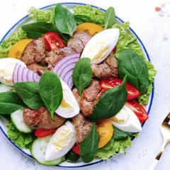 Salade Landaise appétissante avec foies de volaille, œufs durs, tomates, oignons rouges et légumes verts. Quel vin avec une salade landaise ? Un vin blanc sec et fruité.