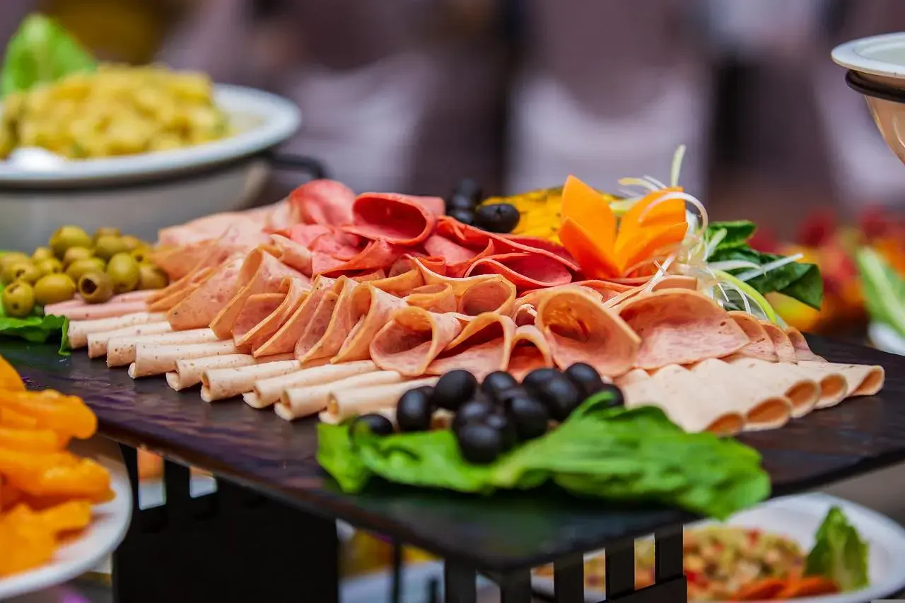 Plateau de charcuterie variée, olives, carottes sculptées. Une belle idée buffet froid pas cher pour 50 personnes.