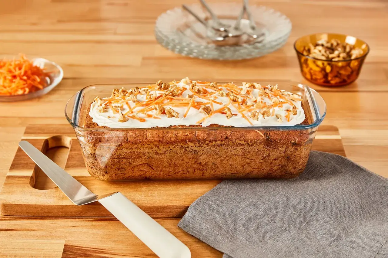 Gâteau aux carottes dans un plat en verre, garni de glaçage, carottes râpées et noix. Est-ce que le verre va au four ? Oui, ce plat en verre est conçu pour la cuisson.