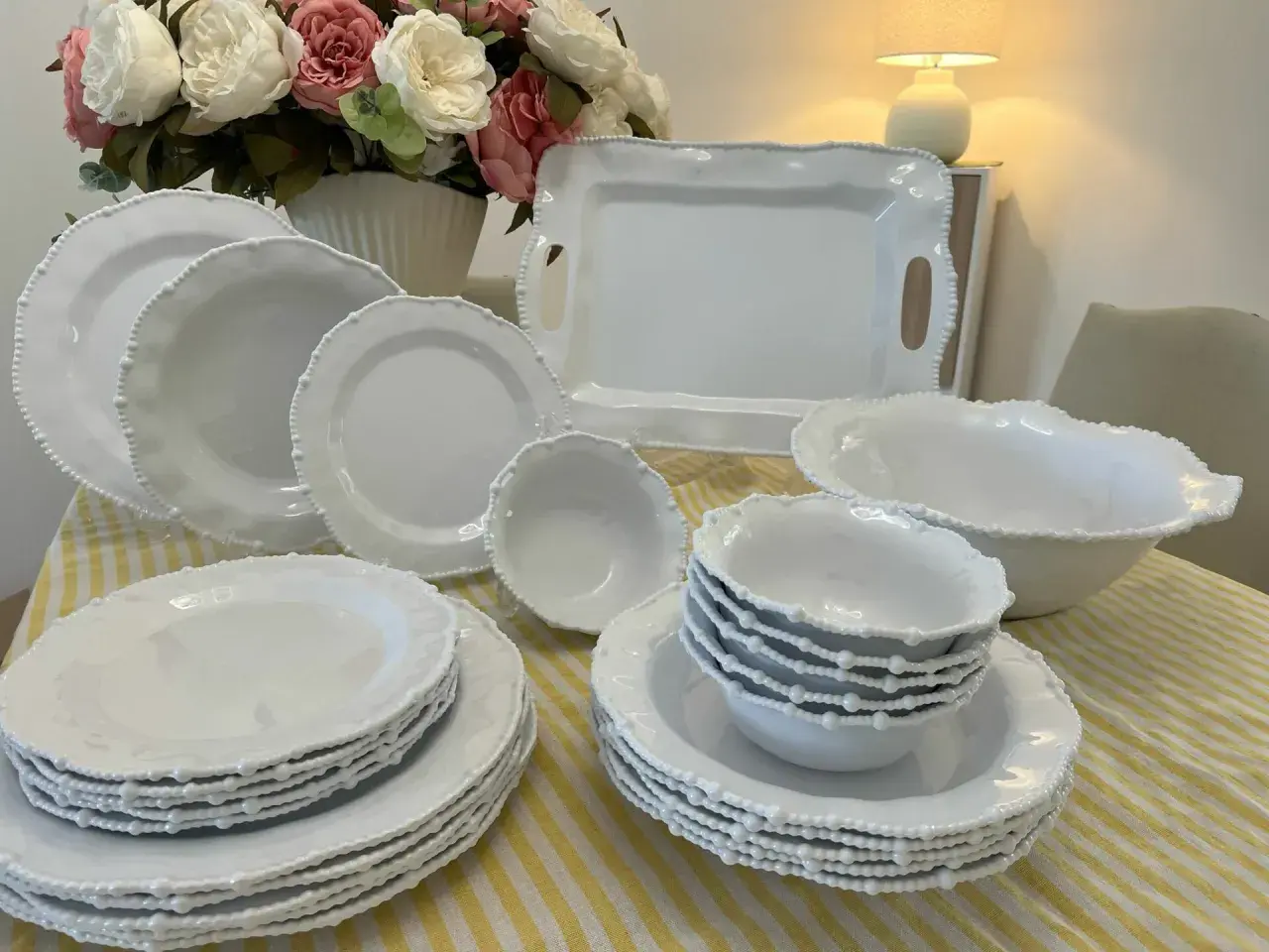 Vaisselle blanche en mélamine, joliment décorée de perles. Attention, la mélamine peut présenter un danger si chauffée.