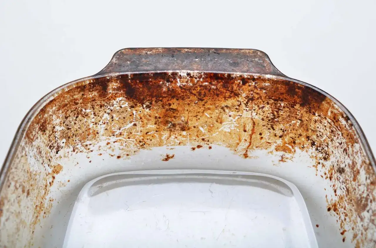 Gros plan sur un plat tr&egrave;s sale, incrust&eacute; de graisse br&ucirc;l&eacute;e. Une image qui montre bien comment d&eacute;graisser un plat.