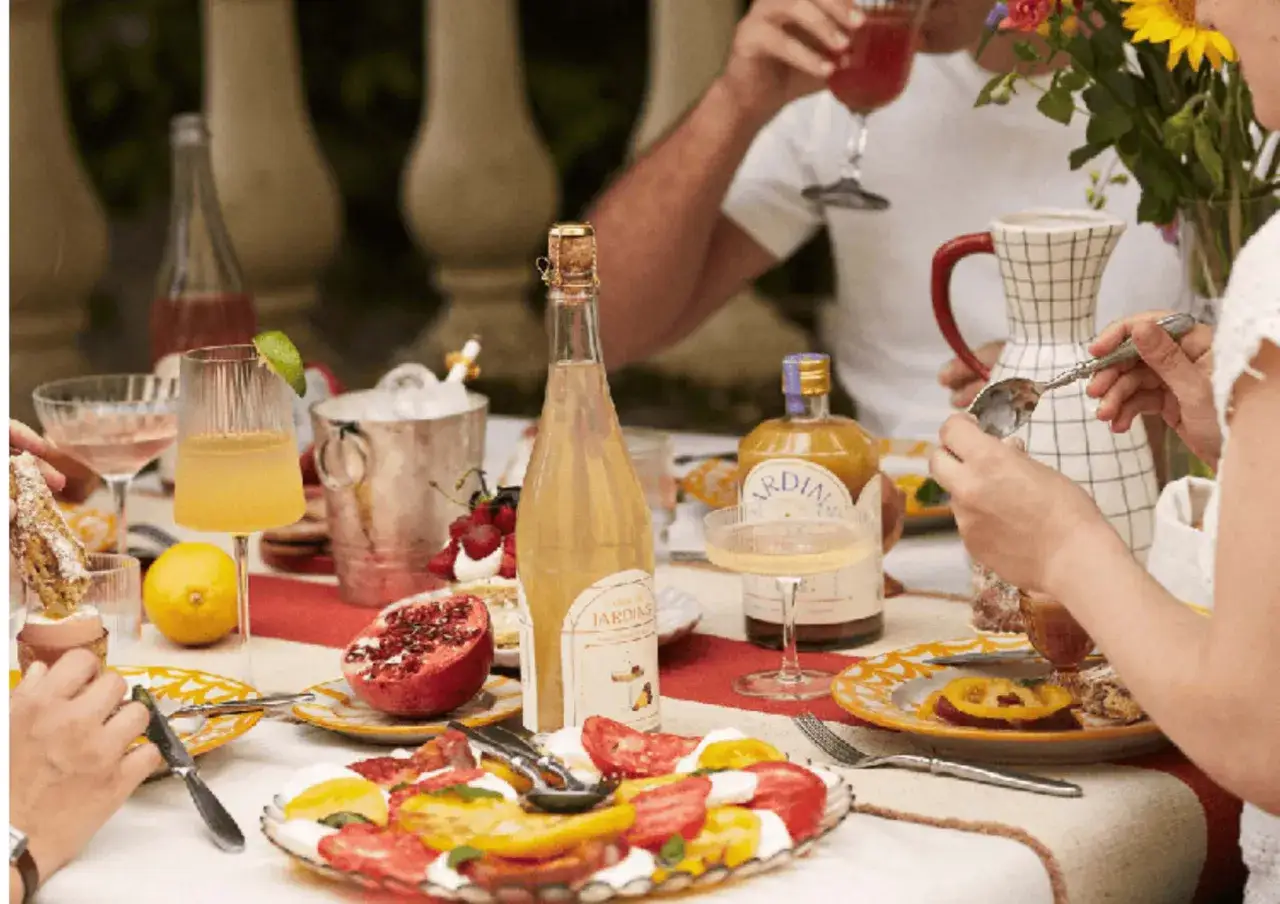 Un délicieux apéro sans alcool avec des fruits frais, des boissons pétillantes et des gourmandises sur une table dressée avec soin.